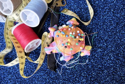 High angle view of sewing items on glitter