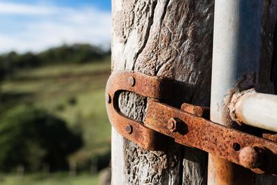 Close-up of rusty metal against sky.
farm gate hinge
