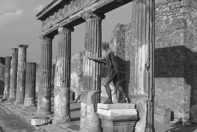 Statue against old building