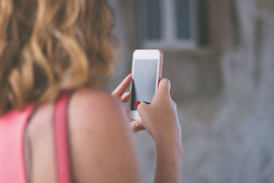 Rear view of woman using mobile phone