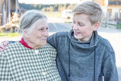 Smiling grandmother with grandson in autumn