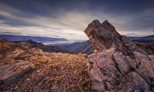 Rock formation on landscape against sky