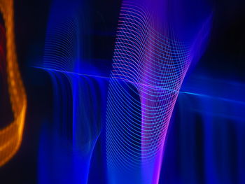 Close-up of light painting against abstract background