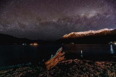 Scenic view of lake against sky at night