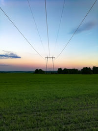 Scenic view of field against sky during sunset