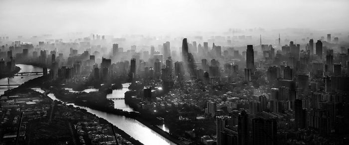 Panoramic view of cityscape in foggy weather