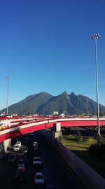 Cars on road against clear blue sky