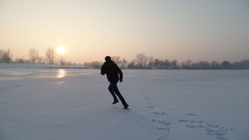 Full length of man on snow covered landscape