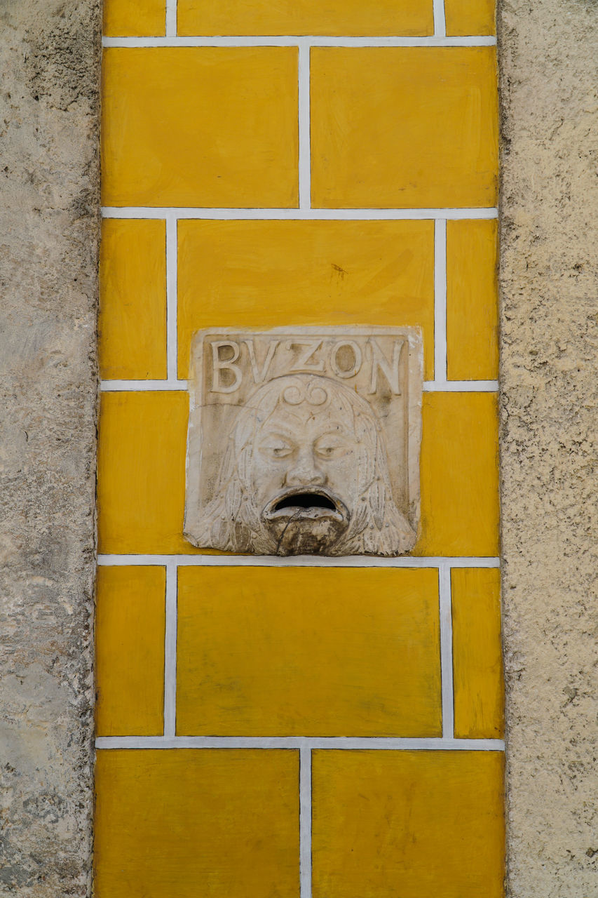 CLOSE-UP OF SCULPTURE ON WALL