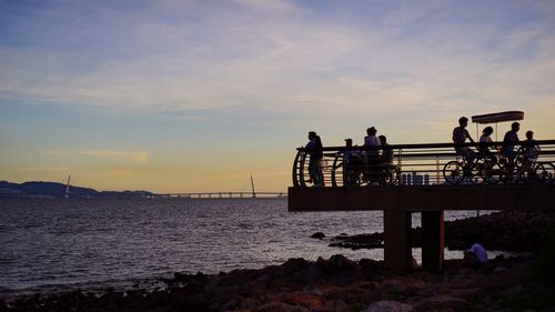 Pier on sea at sunset