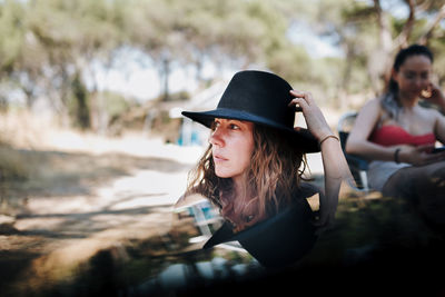 Portrait of beautiful young woman in hat