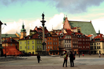 People in city against sky