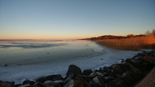 Scenic view of sea against sky at sunset