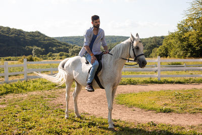 Young woman riding horse