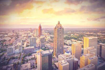 Aerial view of cityscape against sky during sunset