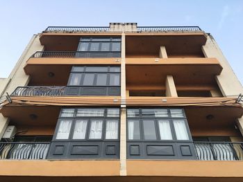 Low angle view of building against clear blue sky