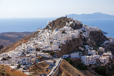 High angle view of townscape by sea against sky