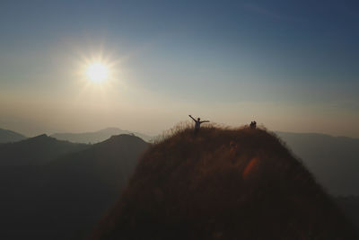 Scenic view of silhouette mountains against sky during sunset