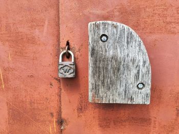 Padlock on closed rusty door