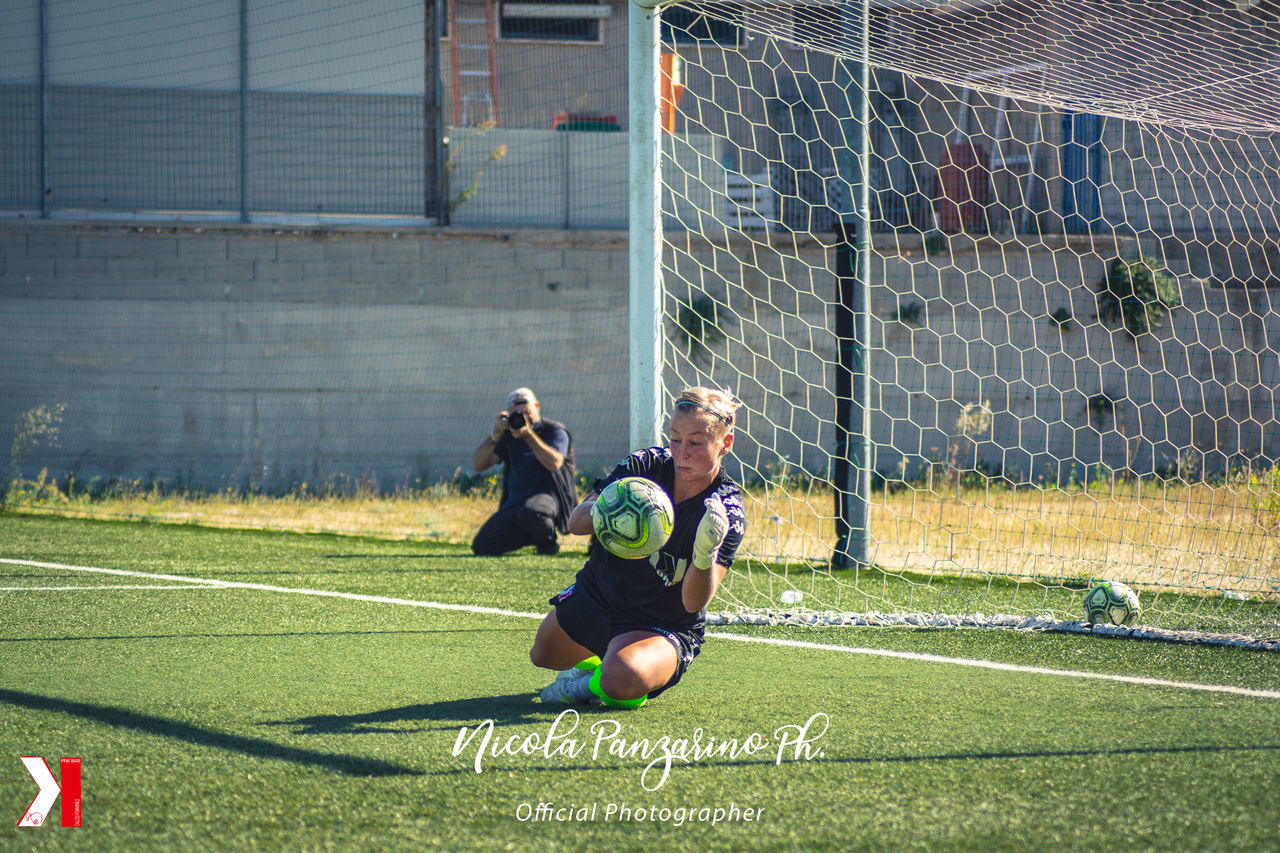 FRIENDS PLAYING SOCCER ON FIELD