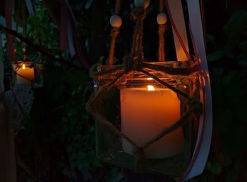 Close-up of illuminated candle at night