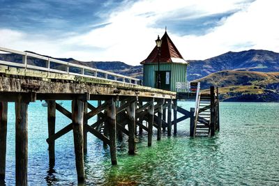 Pier over lake against sky