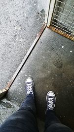 Low section of man standing on footpath