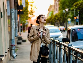 Woman standing on city street