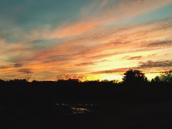 Scenic view of silhouette landscape against sky at sunset