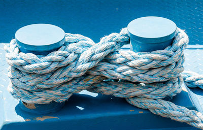 Close-up of rope tied on wooden post