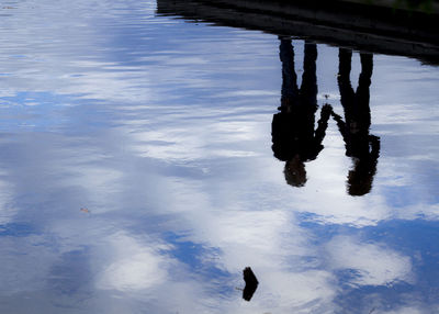 Low section of man standing in lake