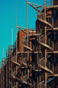 Low angle view of buildings against clear blue sky