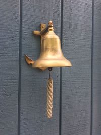 Low angle view of electric lamp hanging on wall