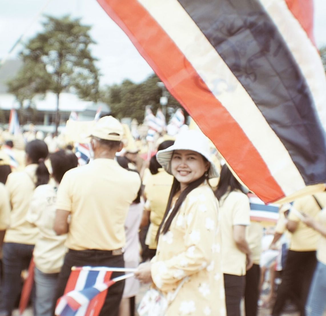 group of people, adult, men, day, clothing, crowd, women, person, hat, outdoors, standing, flag, emotion, happiness, patriotism, smiling, city, young adult, female