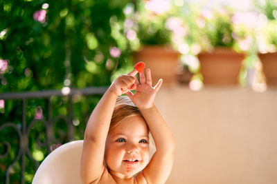 Portrait of girl with arms raised