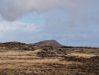 Scenic view of arid landscape against sky