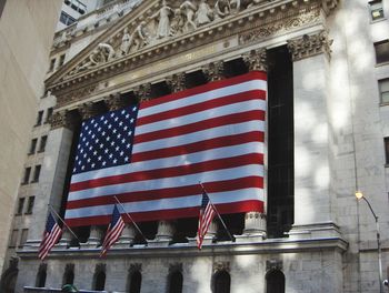 Low angle view of flag against buildings in city