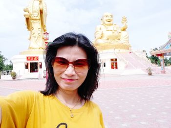 Portrait of woman standing outside temple