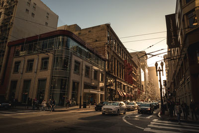 Cars on road against buildings
