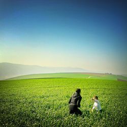 Scenic view of grassy field against sky