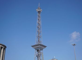 Low angle view of communications tower against sky