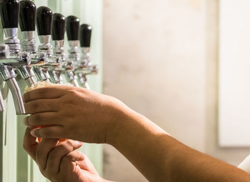 Close-up of hand holding bottle