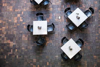 High angle view of tables and chairs arranged in cafe