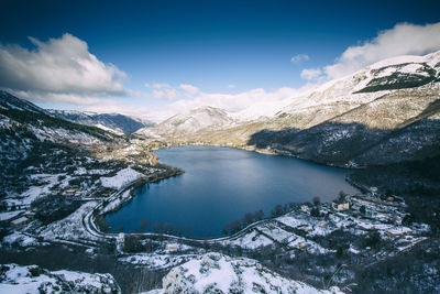 Scenic view of lake and snowcapped mountains against sky