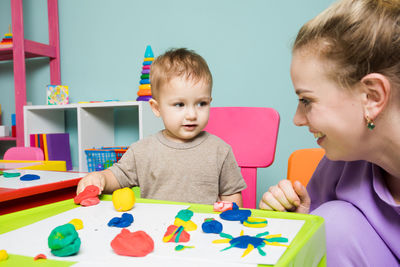 Portrait of cute boy with toys on table