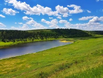 Scenic view of landscape and lake against sky
