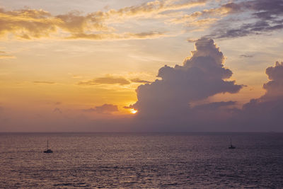 Calm sea with sunset sky and sun through the clouds over. meditation ocean and sky background