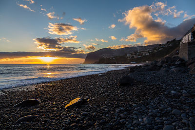 Scenic view of beach against sky during sunset