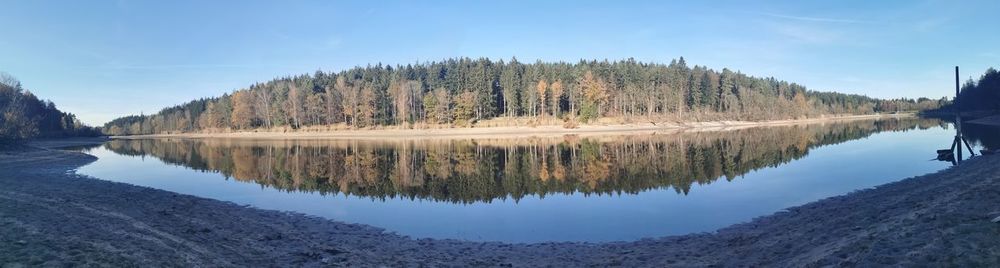 Panoramic view of lake and trees in forest against sky