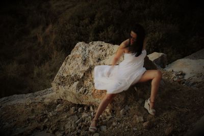 Woman sitting on rock